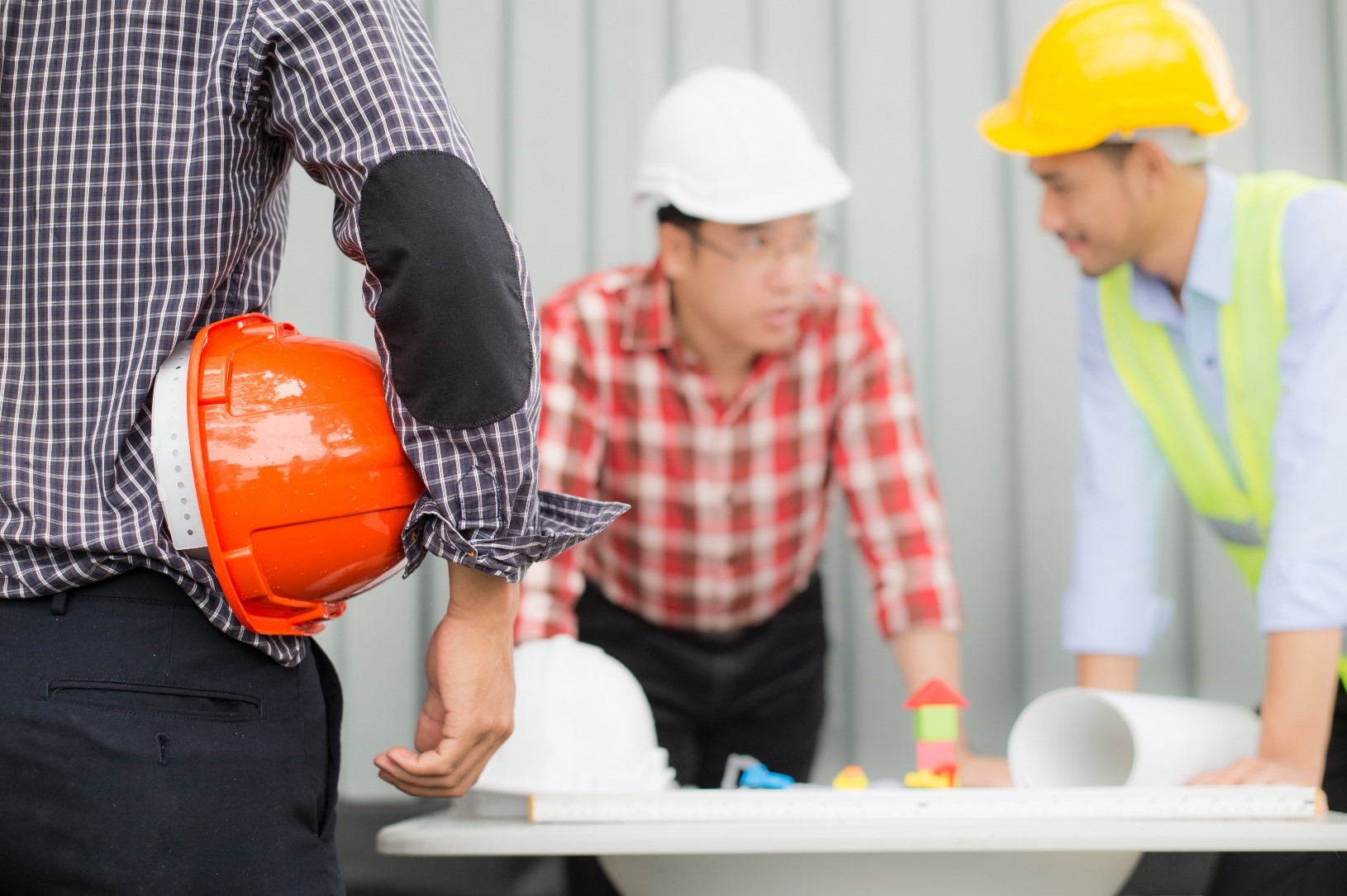 Workers in helmets planning a project