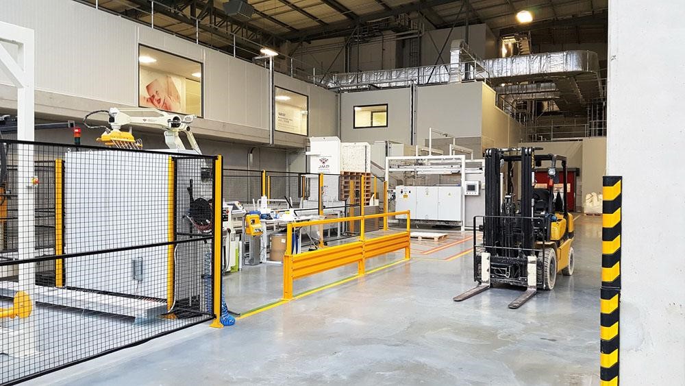 A DexSafe ForkSafe safety barrier installed in a warehouse next to a forklift